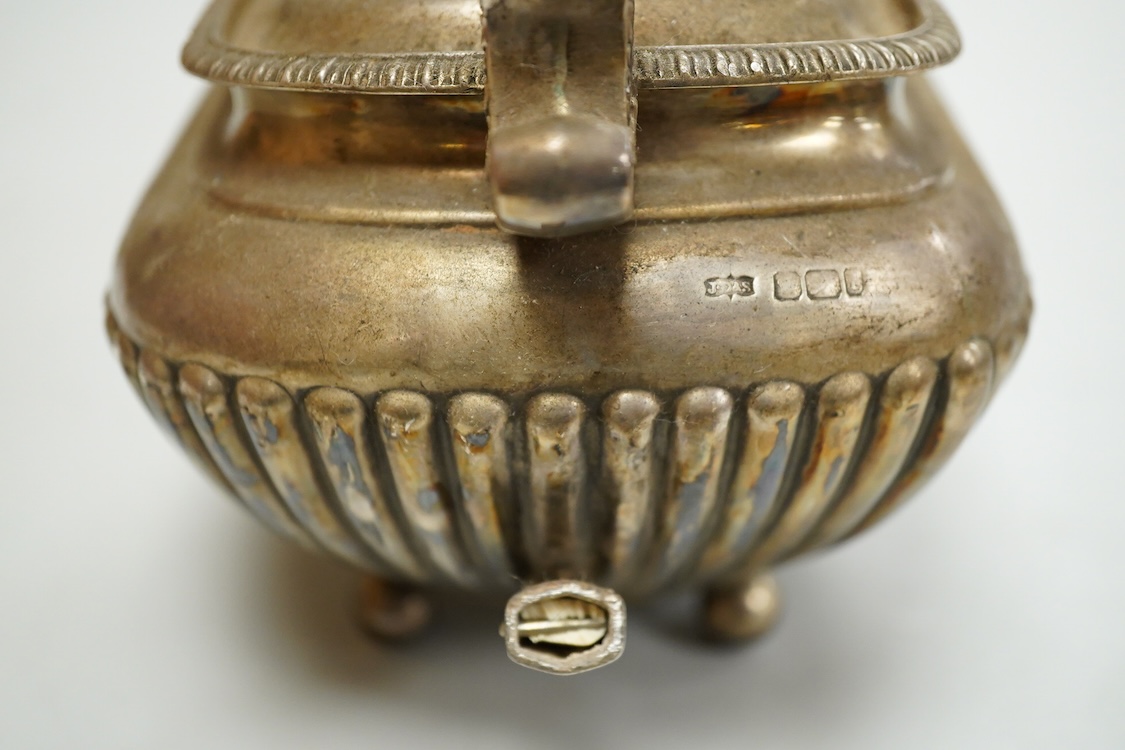 An early 20th century demi-fluted silver oval teapot, by James Dixon & Sons, Sheffield, 1903?, handle detached, together with a George III pierced silver oval salt, by Robert Hennell I, with glass liner(a.f.), gross weig